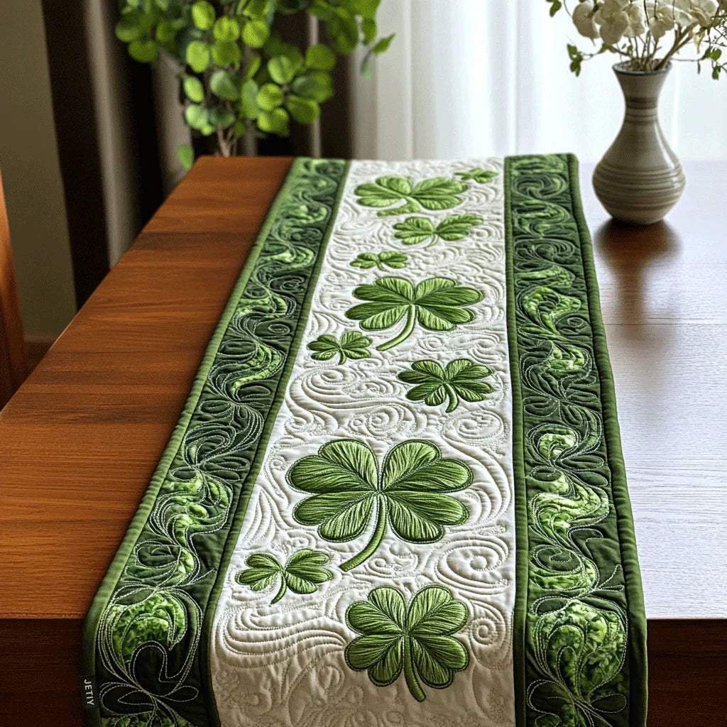 Quilted table runner with an Emerald Forest design of layered deep green woodland with ferns, tall trunks and light coming through the canopy