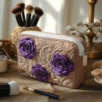 Quilted make-up bag with an Enchanted Rose design of deep purple roses and layered petals against shadowed green leaves
