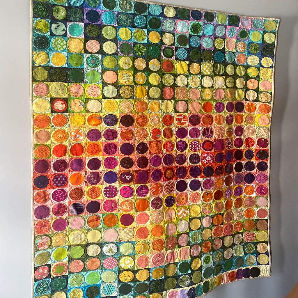Four Seasons Dots quilted throw – seasonal coloured dots in rows