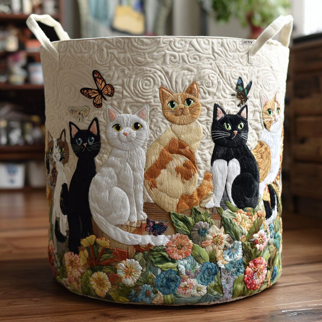Quilted laundry basket with a Garden Cats design of cats walking among watering cans, terracotta pots, lavender and daisies, with wave stitching and carry handles