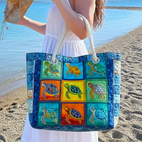 Woman carrying the Tranquil Turtle quilted beach bag along the shore