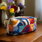 Quilted make-up bag with a Groovy Waves design of rolling retro waves in mustard, rust and cream with small toadstools between them