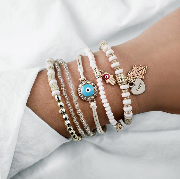 Stack of beaded boho bracelets with charms
