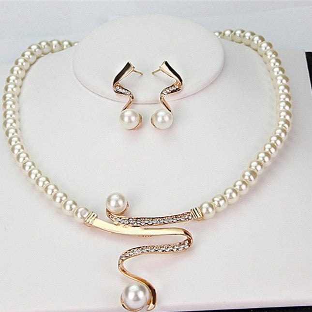 Pearl necklace with a crystal swirl and matching earrings