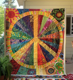 Patchwork Peace Sign quilted throw – peace sign in warm patchwork rays