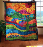 Sunset Waves quilted throw – red sun over rolling coloured waves