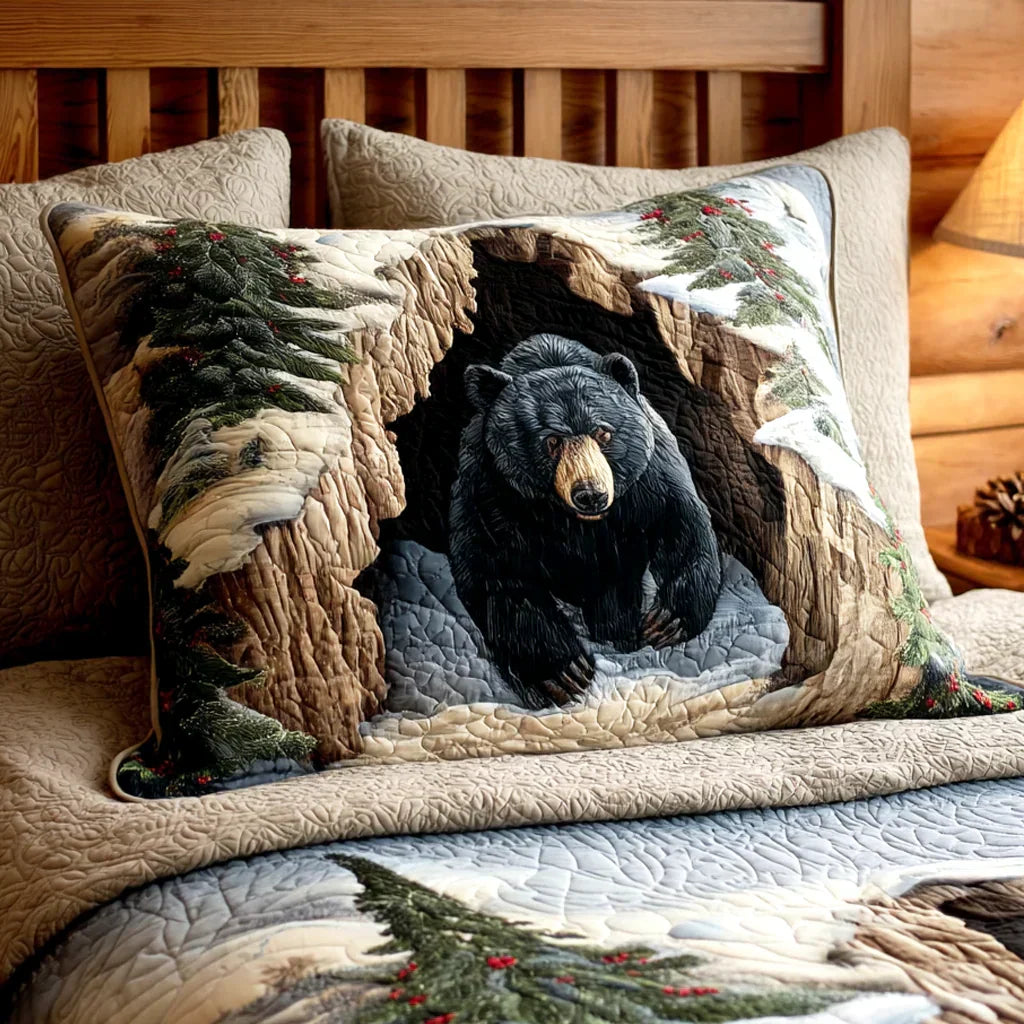 Quilted pillowcase with the Christmas Den design, a warmly lit woodland den among snow-laden fir trees against a cold blue sky