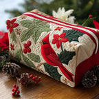 Quilted make-up bag with a red cardinal perched amongst glossy holly leaves, scarlet berries and open poinsettias in the Holly Cardinal design