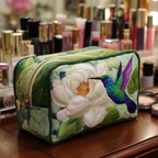 Hummingbird Charm quilted make-up bag with violet hummingbird beside a white magnolia on green