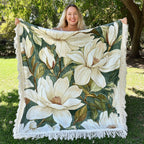 White Magnolias fringed throw – large white magnolias among green leaves