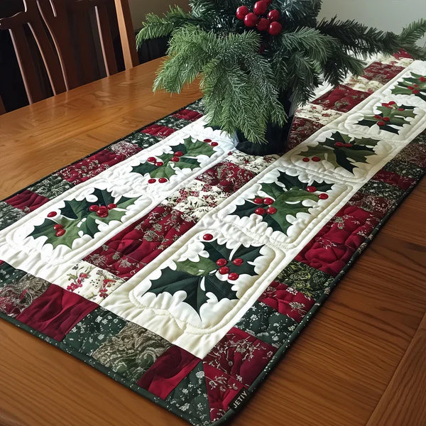 Quilted table runner with a Jingle Bells design of gold and silver bells hanging from holly sprigs and ribbon on deep Christmas red