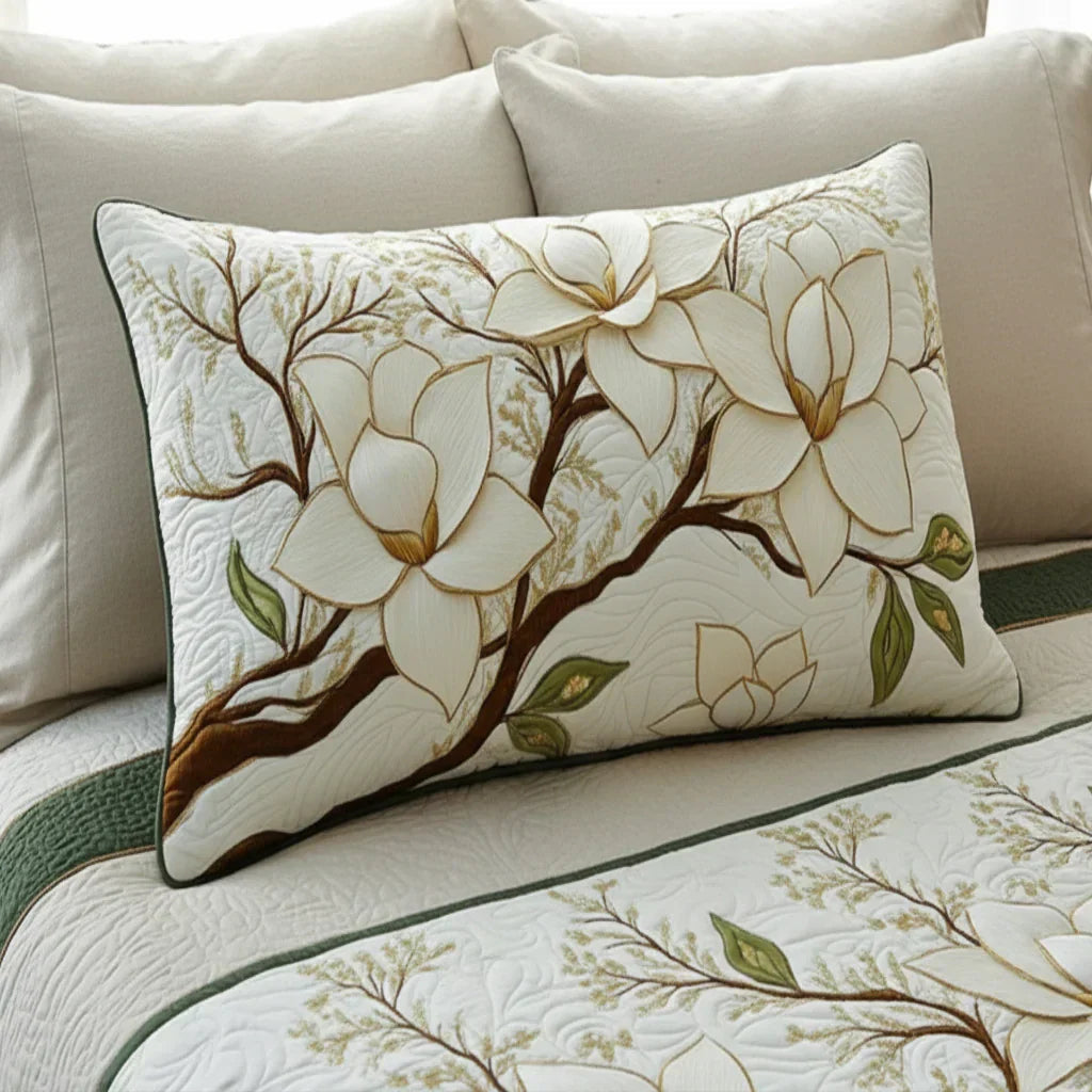 Quilted pillowcase with the Magnolia Blossom design, cream and pale pink magnolia blooms on dark bare branches over wave-stitch quilting