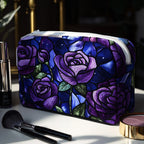 Quilted make-up bag with deep wine and plum roses opening against a near-black ground, framed by dark green leaves, in the Midnight Rose design