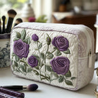 Quilted make-up bag with pale violet roses lit by cool silver light against a deep dusk-blue ground in the Moonlit Bloom design