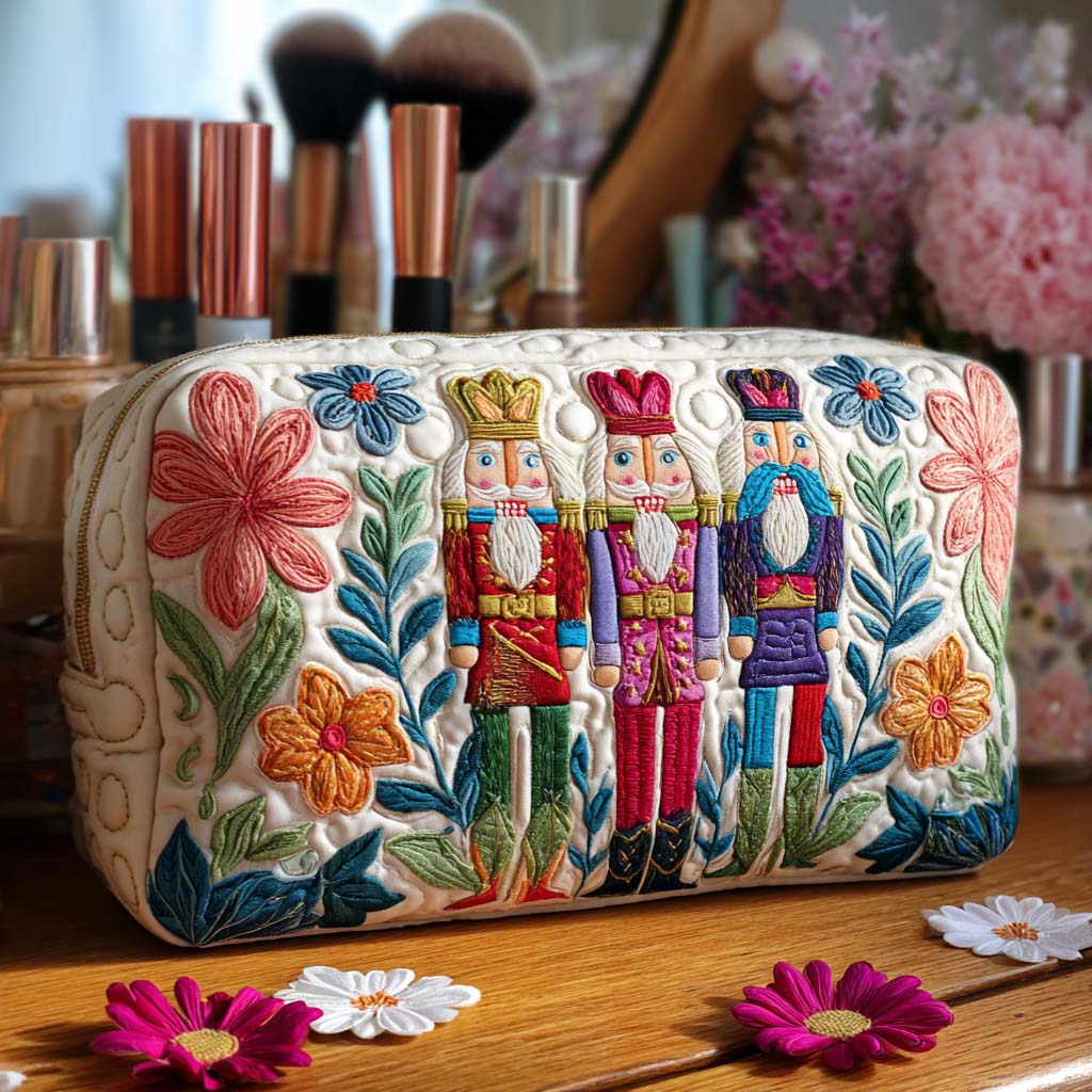 Quilted make-up bag with small nutcrackers scattered in a repeating pattern amongst tiny baubles, stars and pine sprigs in red, cream and gold in the Nutcracker Charm design