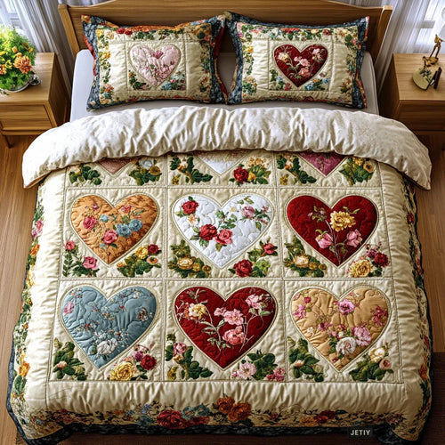 Quilted bedspread set with rose, cream and dusky red hearts set into printed squares in the Patchwork Hearts design