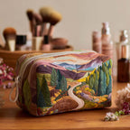 Quilted make-up bag with the Peaceful Valley design of a camper van crossing a daisy meadow in soft greens and sunny yellows