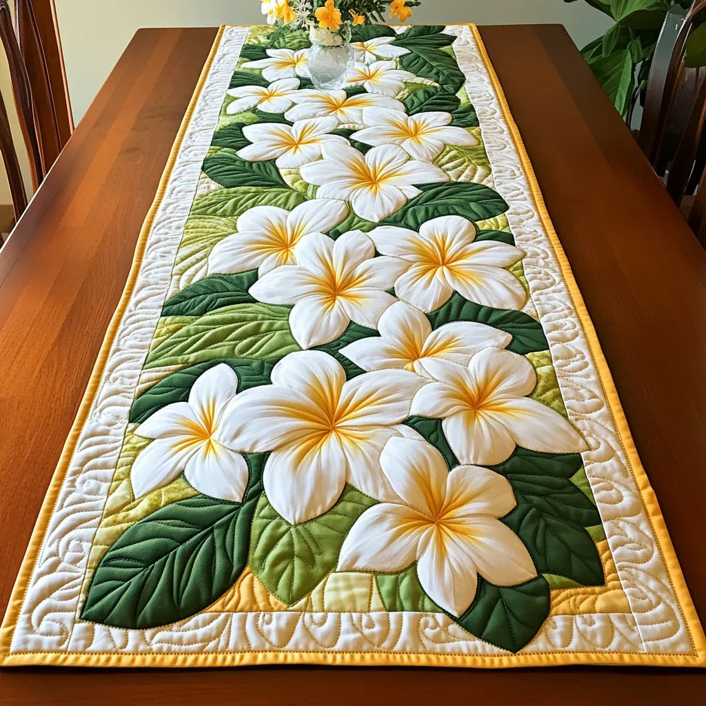 Quilted table runner with a Frangipani Blooms design of creamy frangipani flowers with golden centres against deep glossy leaves