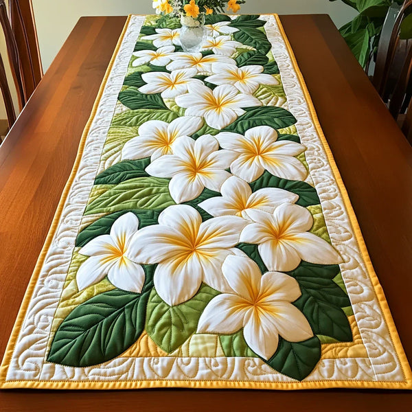 Quilted table runner with a Frangipani Blooms design of creamy frangipani flowers with golden centres against deep glossy leaves