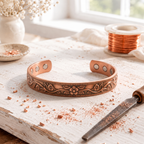 Magnetic copper cuff with a raised floral scroll and beaded border