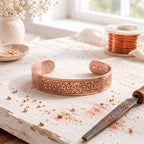 Wide magnetic copper cuff with an ornate engraved scroll panel