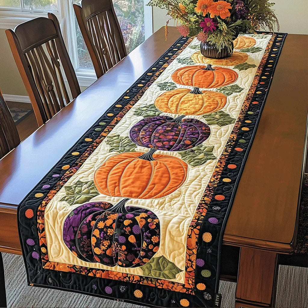 Quilted table runner with a trailing pumpkin vine, curling tendrils and russet leaves