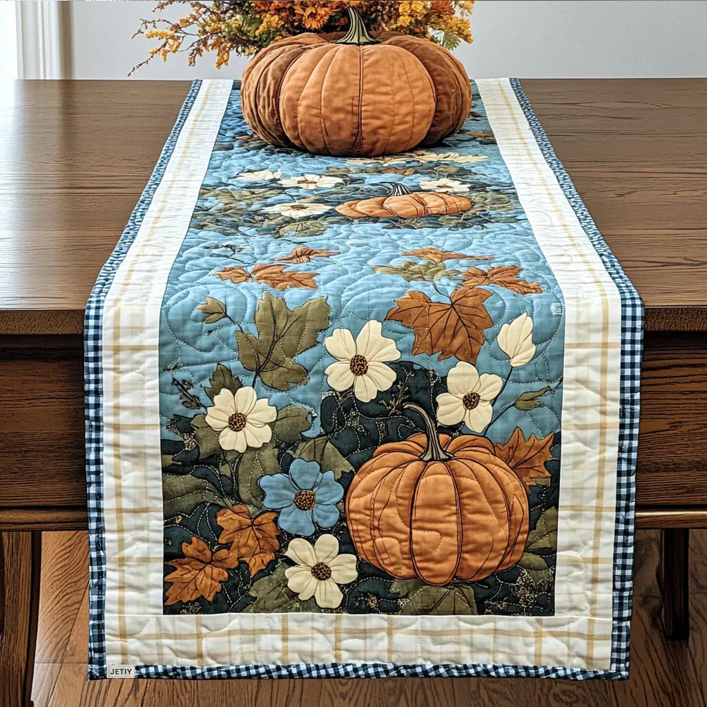 Quilted table runner with pumpkins, cinnamon sticks and star anise in warm spice tones on cream