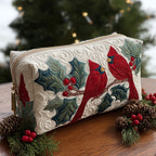 Quilted make-up bag with the Red Feather design of a red cardinal among holly leaves, berries and poinsettia on a deep winter ground