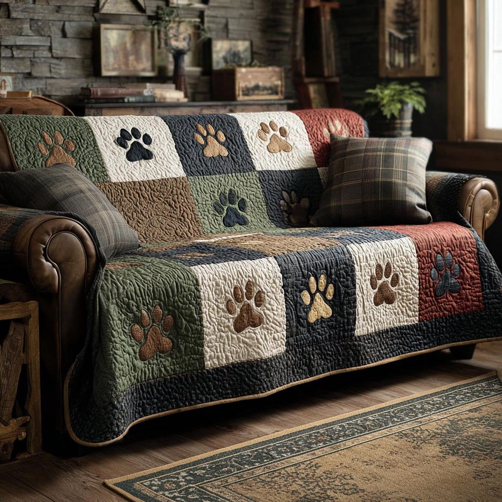 Rustic Paws quilted sofa cover with olive green, cream, navy, barn red and charcoal blocks carrying tan paw prints