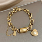 Gold-tone chunky chain bracelet with a heart charm