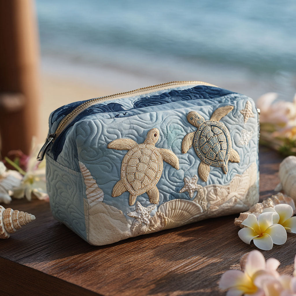 Sandy Shell quilted make-up bag with pale sea turtles swimming across soft blue quilting