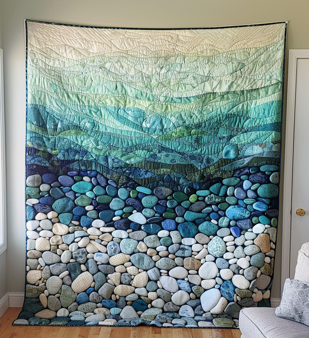 Pebble Shore quilted throw – smooth pebbles beneath soft green waves