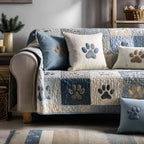Soft Blue Paws quilted sofa cover with denim blue, dove grey and cream squares and paw prints in sand and slate