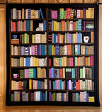 Bookshelf Beauty quilted throw – rows of colourful books on dark shelves