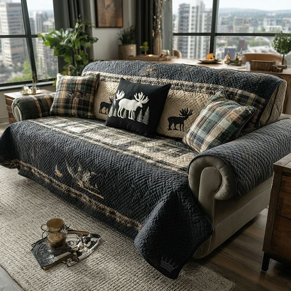 Timberline Haven quilted sofa cover with elk and moose silhouettes on charcoal-navy with green and tan tartan bands