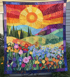 Flower Valley quilted throw – fields of flowers beneath a sunset sky