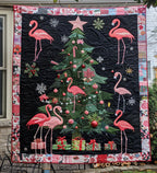 Flamingo Christmas Night quilted throw – pink flamingos round a Christmas tree on black