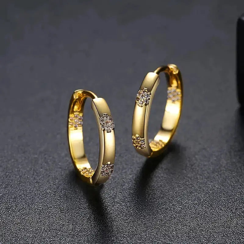 Gold-tone hoop earrings with tiny crystal flowers
