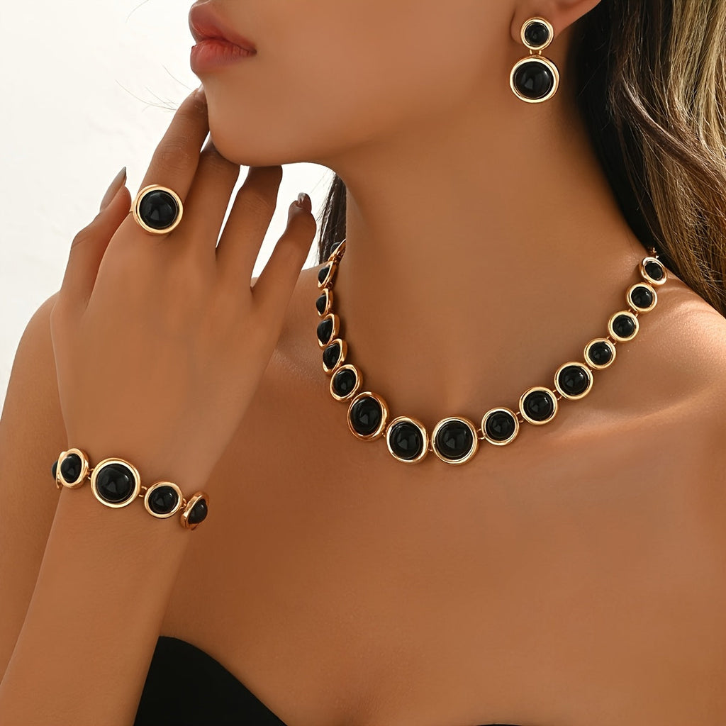 Gold-tone and black cabochon necklace, bracelet, earrings and ring set
