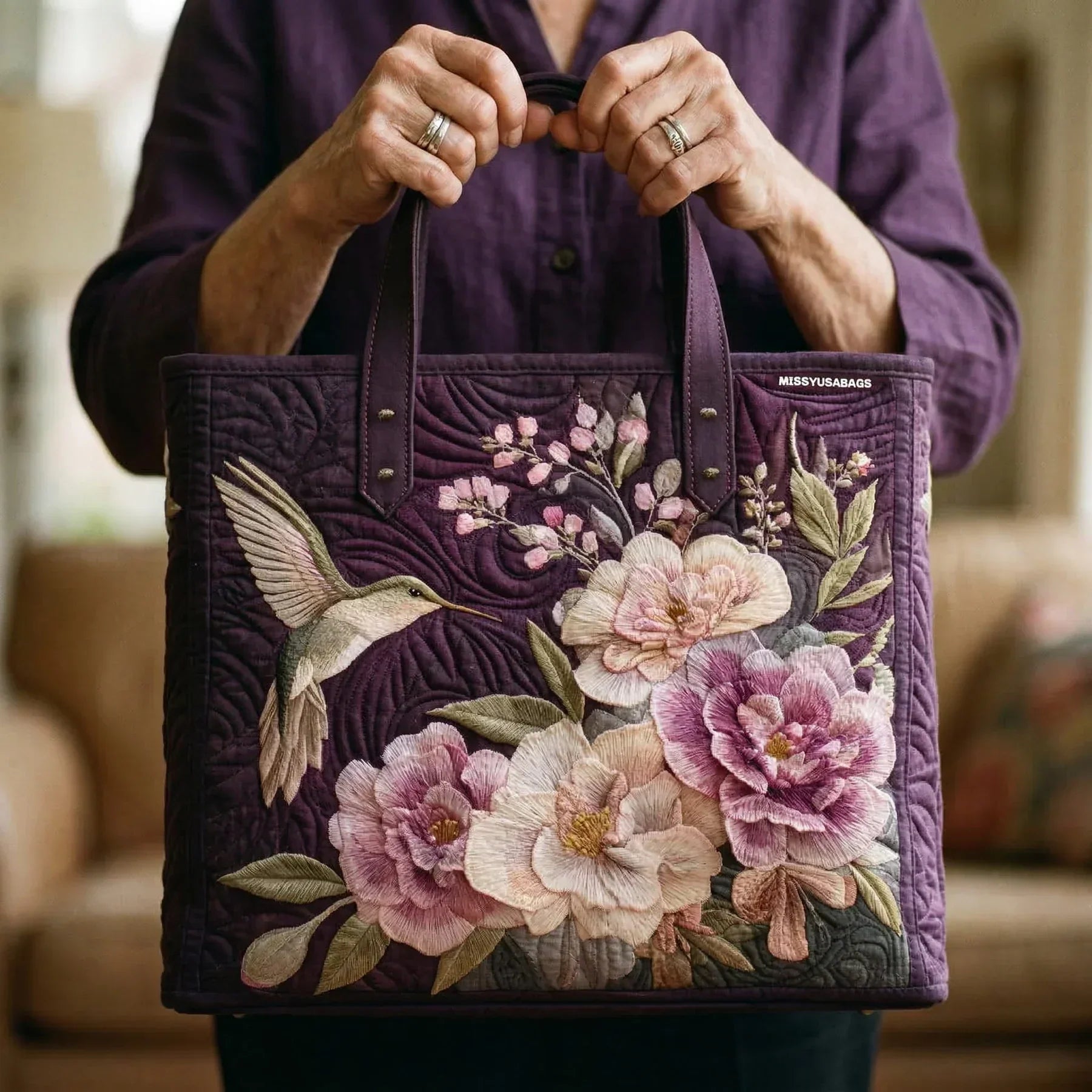 Woman carrying the Hummingbirds and Orchids artisan quilted tote bag