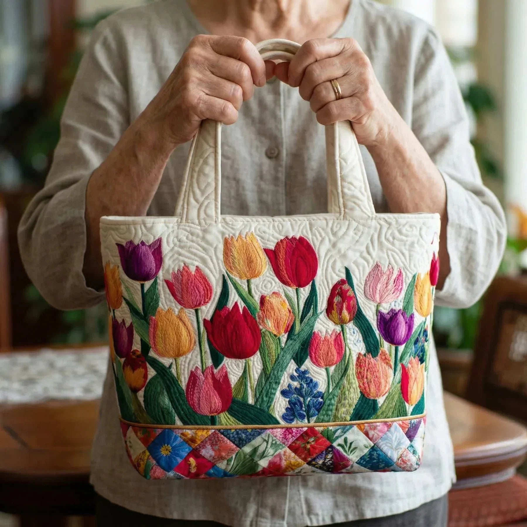 Woman carrying the Tulip Garden artisan quilted tote bag