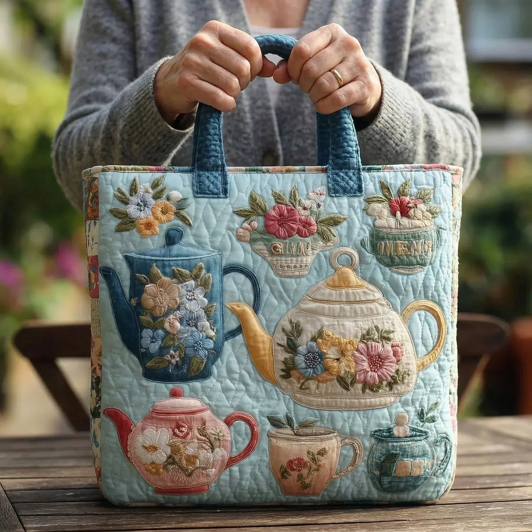 Woman carrying the Cottage Floral artisan quilted tote bag