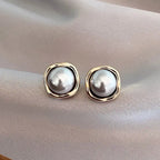 Grey pearl stud earrings in a silver-tone setting