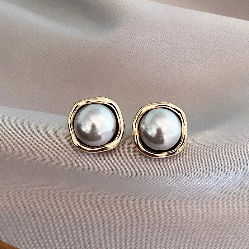 Grey pearl stud earrings in a silver-tone setting