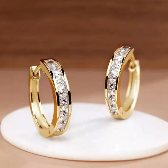 Gold-tone hoop earrings with a row of clear crystals