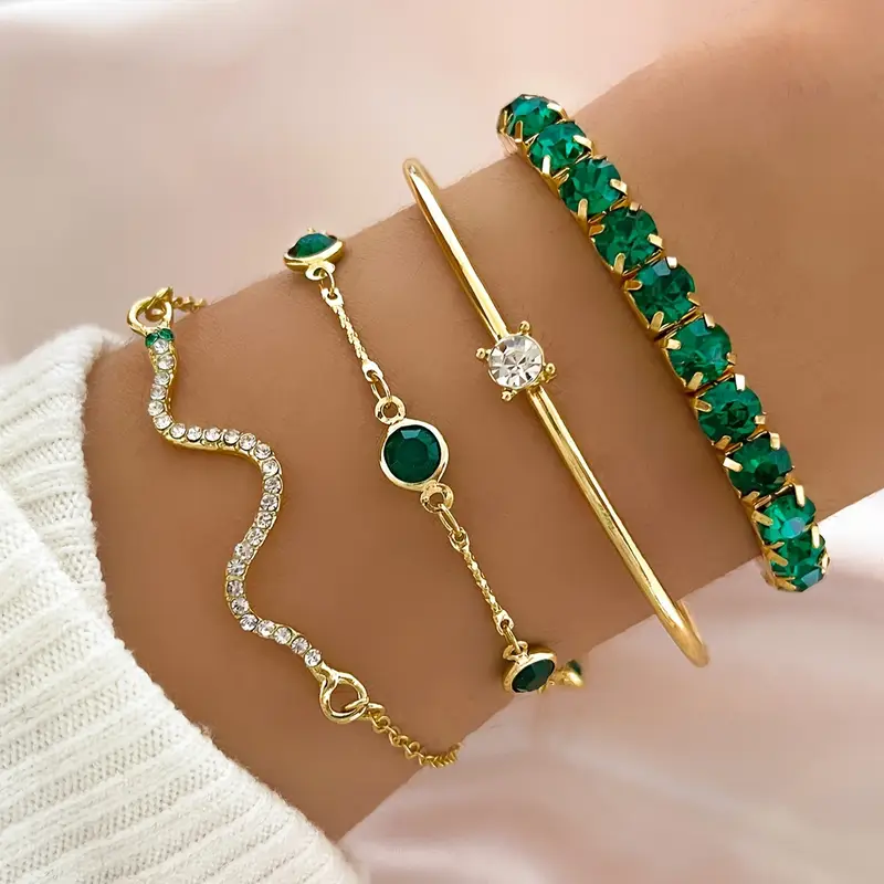 Set of gold-tone bracelets with emerald-green stones