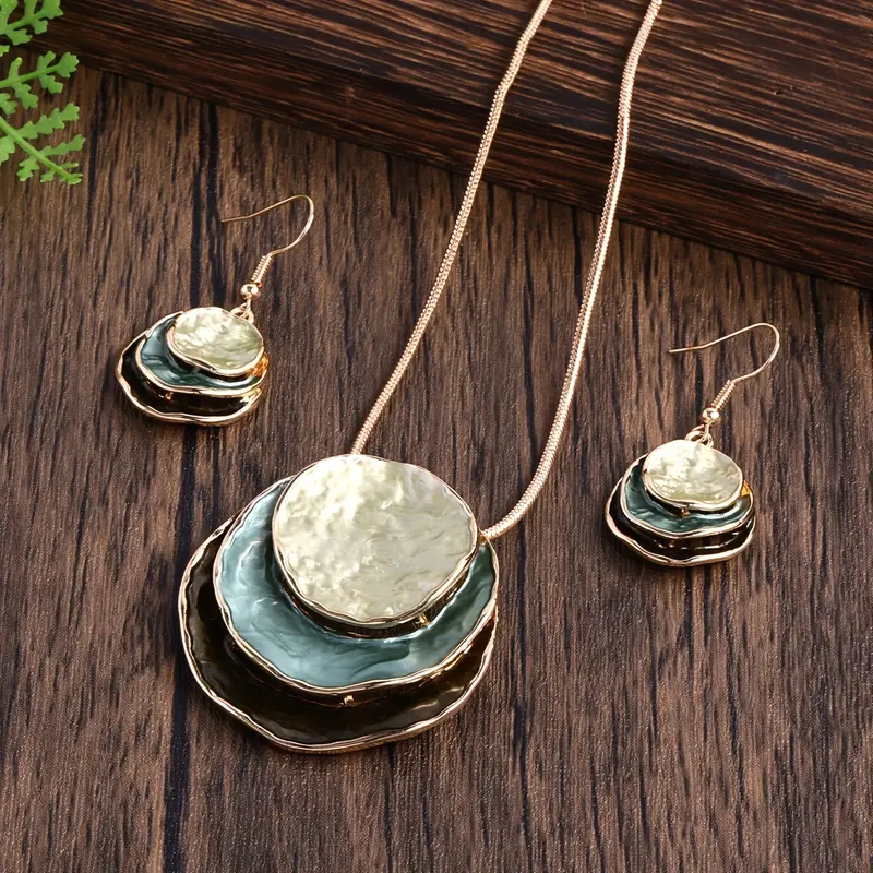 Drop earrings with layered blue-green and gold-tone discs