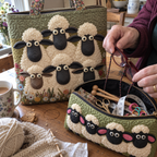 Close-up of the Six Sheep tote quilting with the Cute Herd makeup bag open, holding knitting needles and glasses.