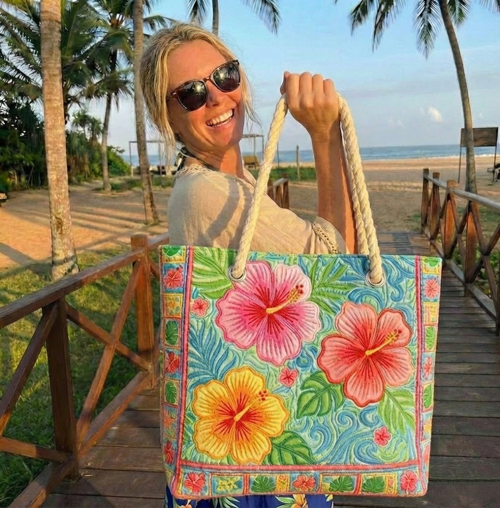 Quilted beach bag with the Tropical Flower design, a large pink and coral hibiscus on broad green leaves