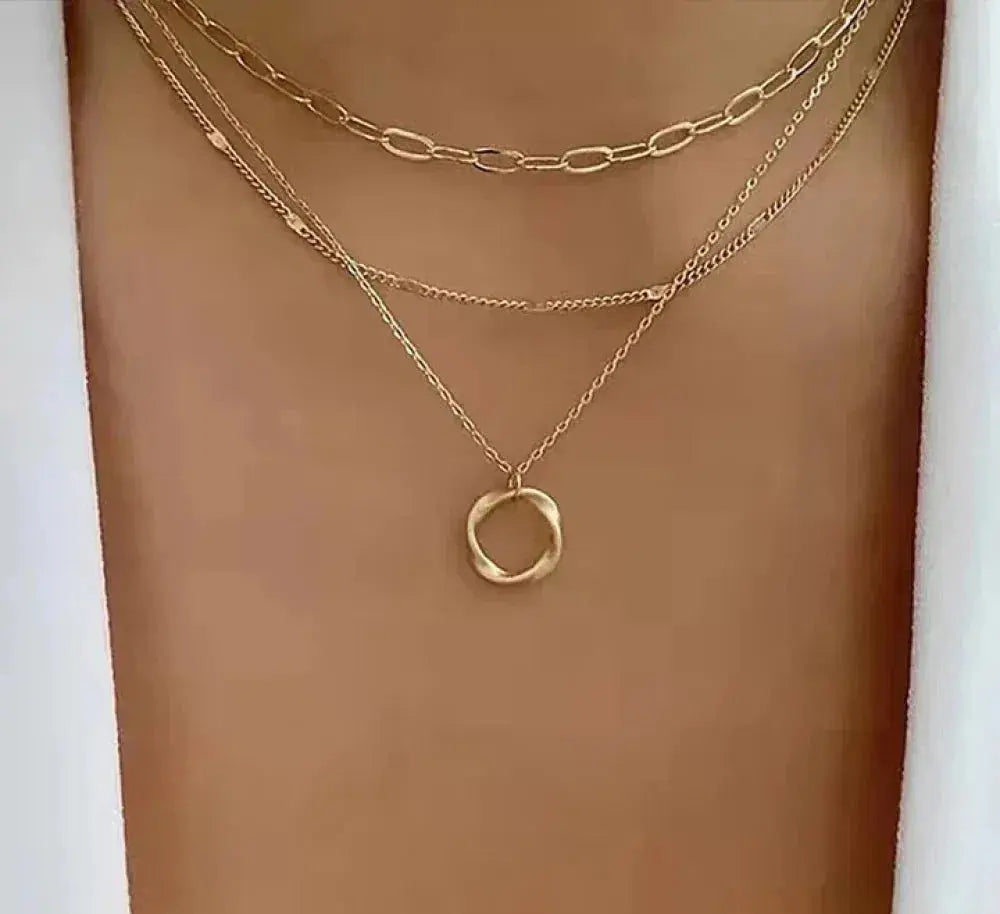 Layered gold-tone necklace with an open circle pendant